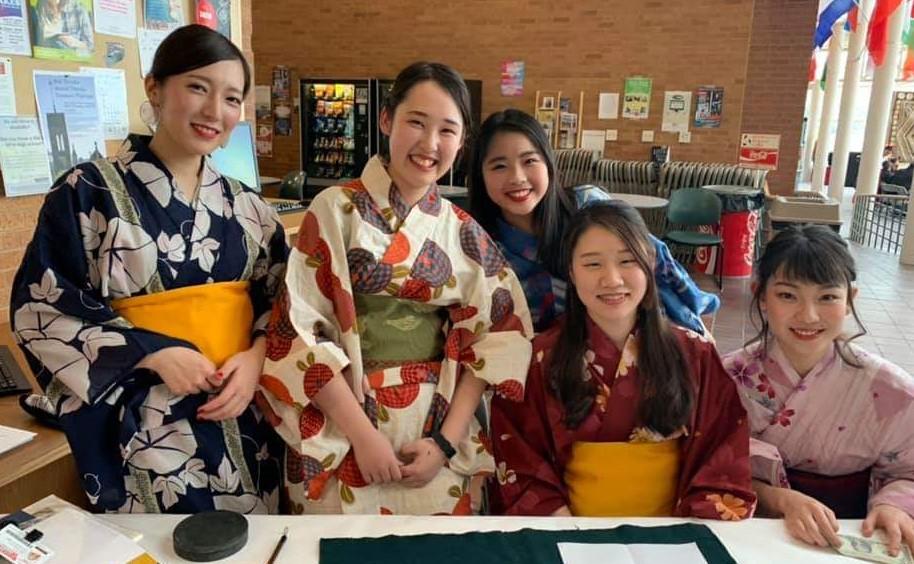 This is an image of Japanese students holding a fundraiser selling tea.