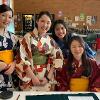 This is an image of Japanese students holding a fundraiser selling tea.