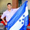 A student holding their country flag of origin. 