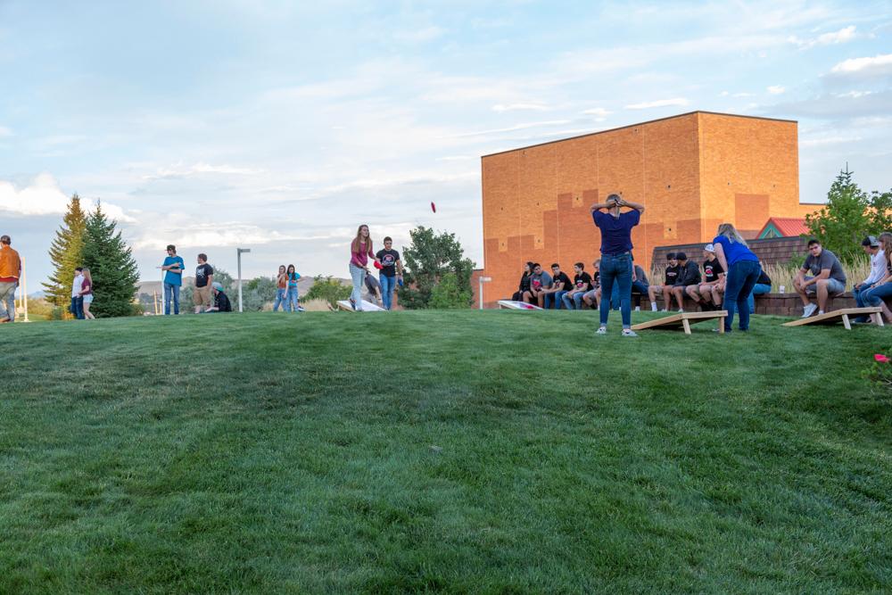 Students outside playing corn hole