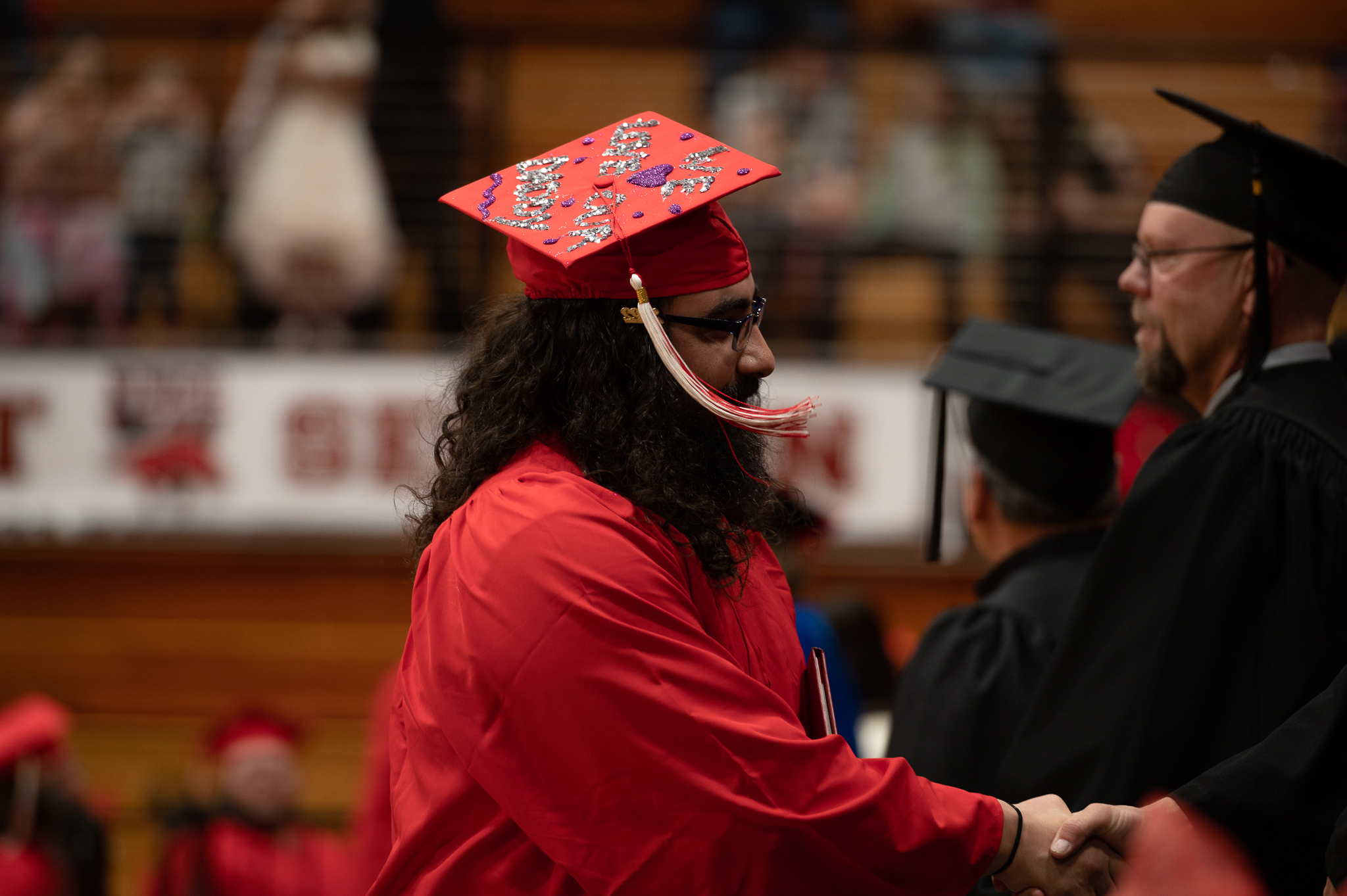 Student handshaking while walking on stage 