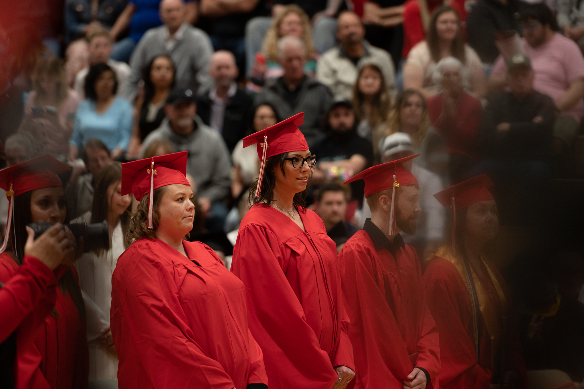 Students standing and sitting during the graduation ceremony