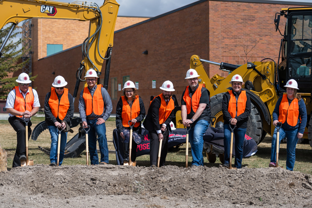 Group photo of project contractors, director of facilities Chris Dever, VP Administrative Services Burt Reynolds and Nursing Chair Heidi Brown posed with golden shovels at construction site. 