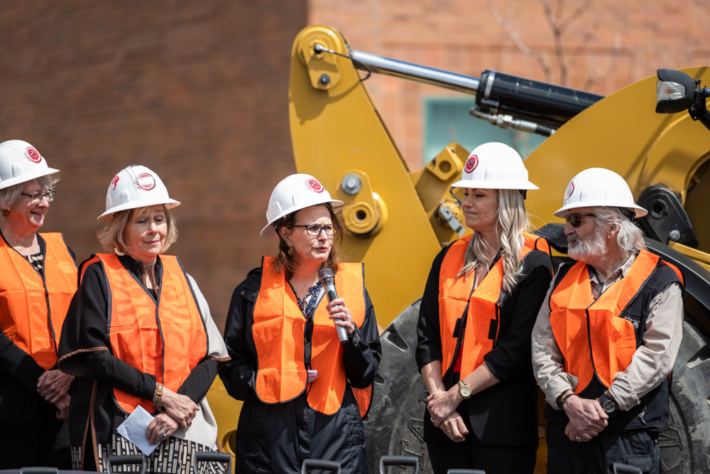 Group photo of Heidi Brown, Nursing Chair talking into Mic surrounded by board members and Dr. Kim Dale President. 