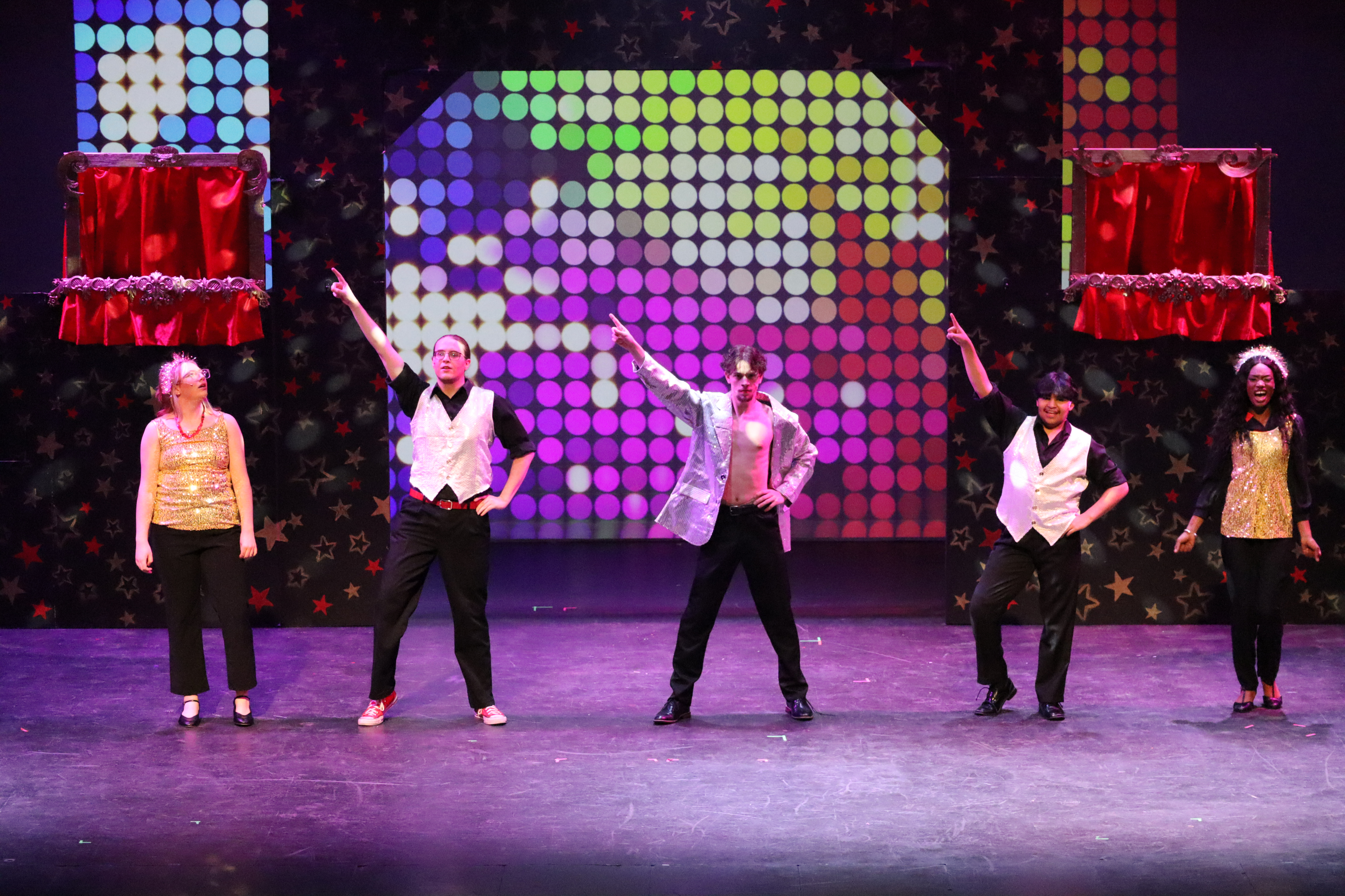 Actors standing in a line on stage.