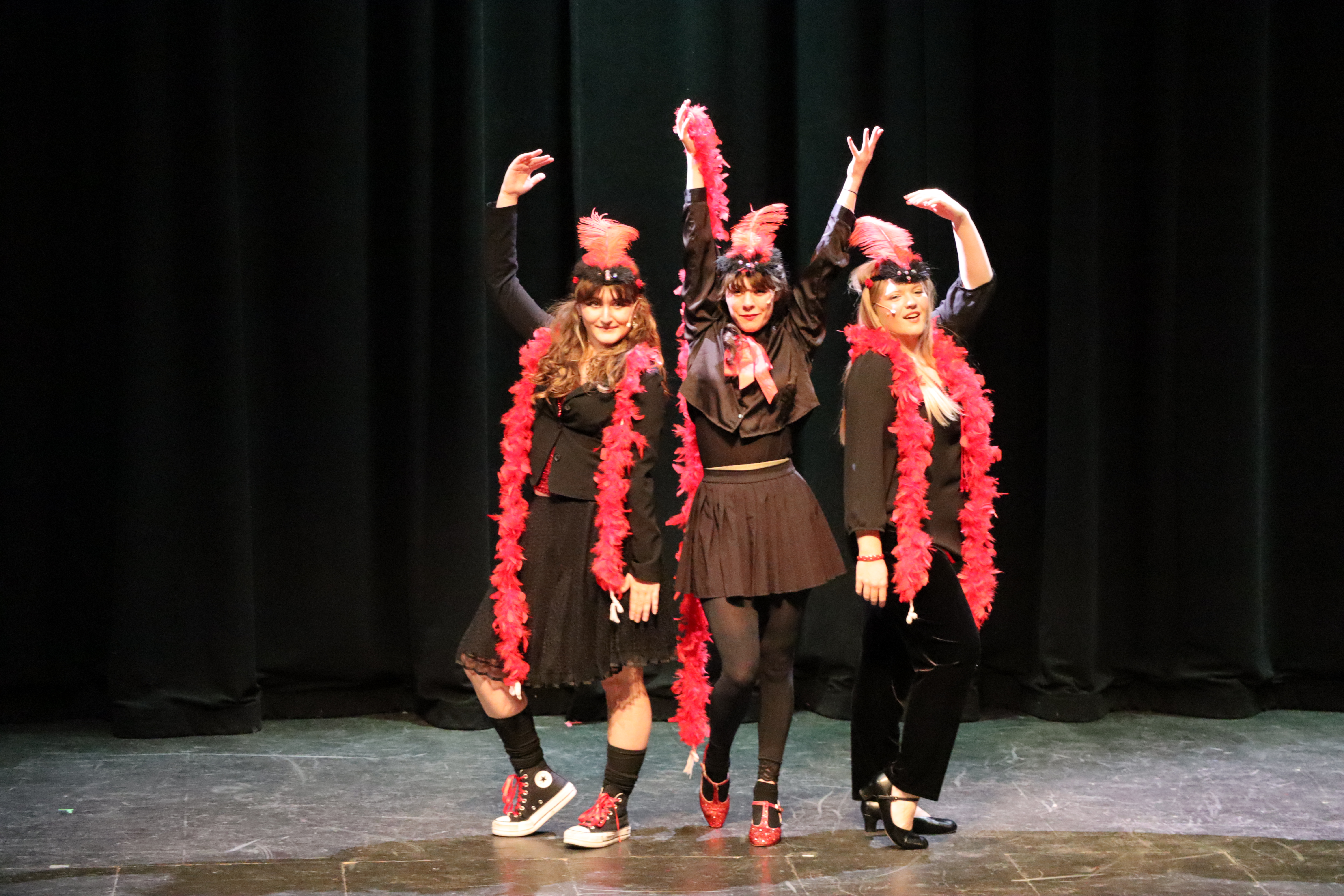 Three women in a line on stage