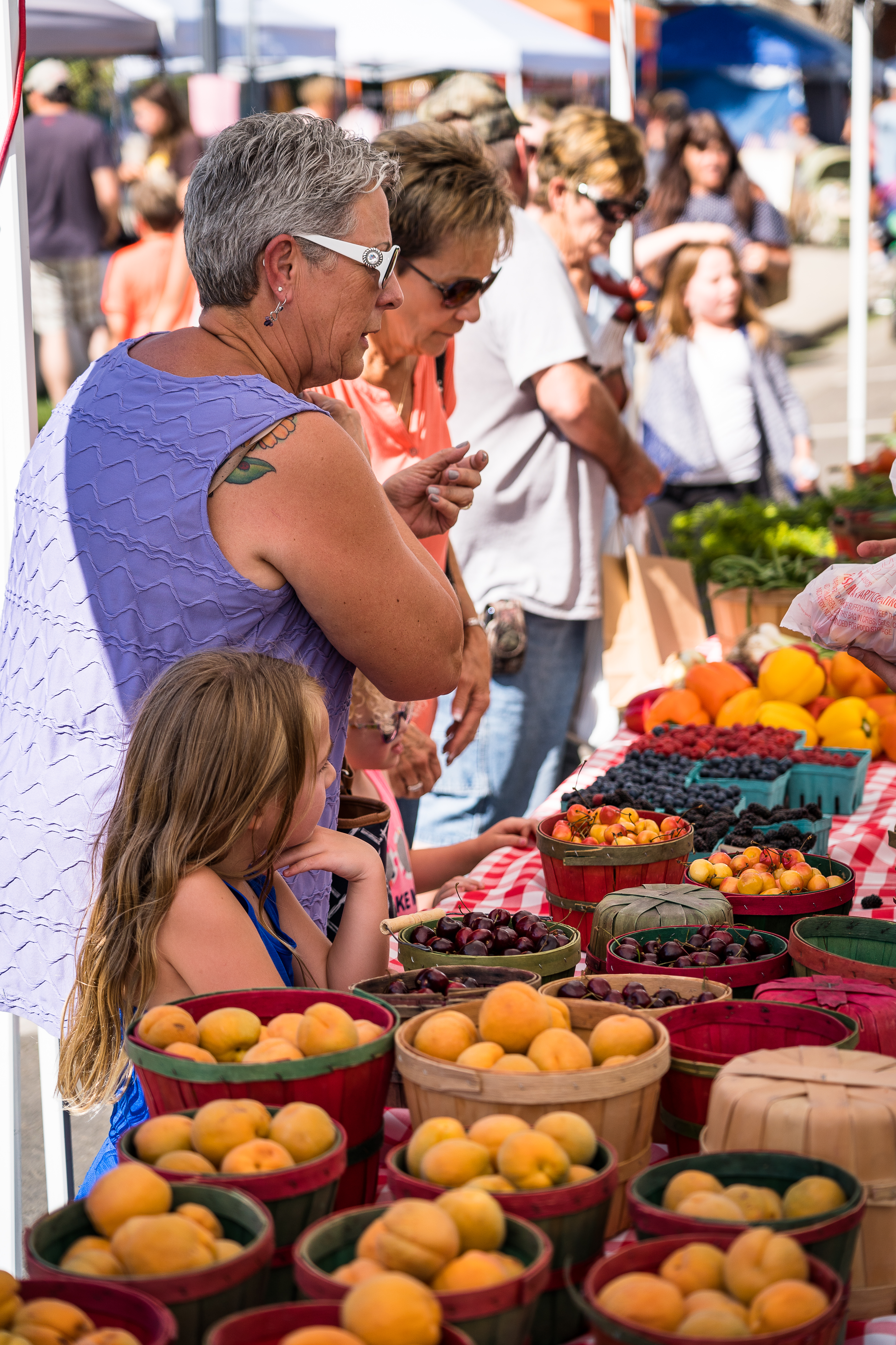 People shopping at a farm stand. 