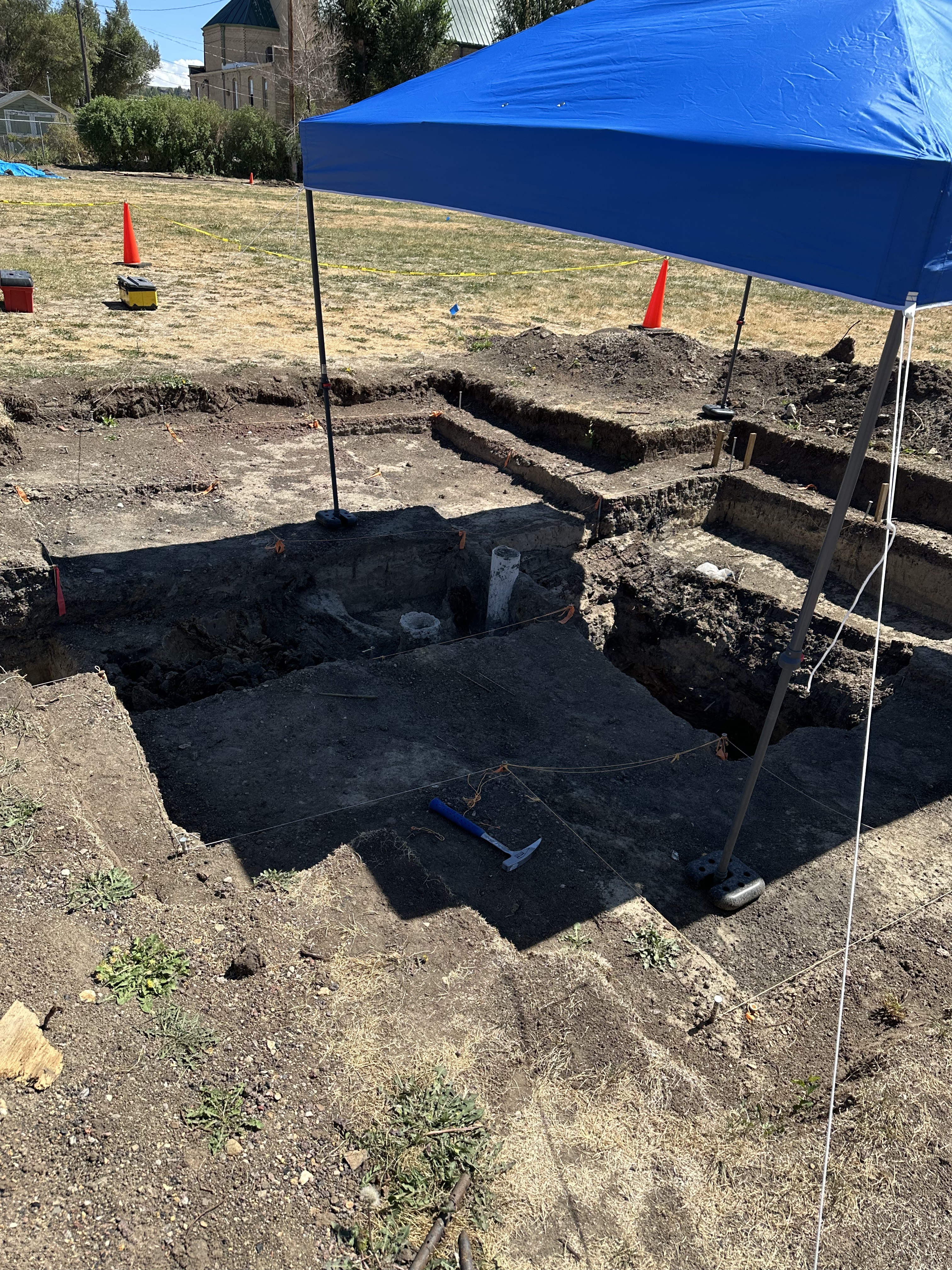 A canopy sits over an active dig site.