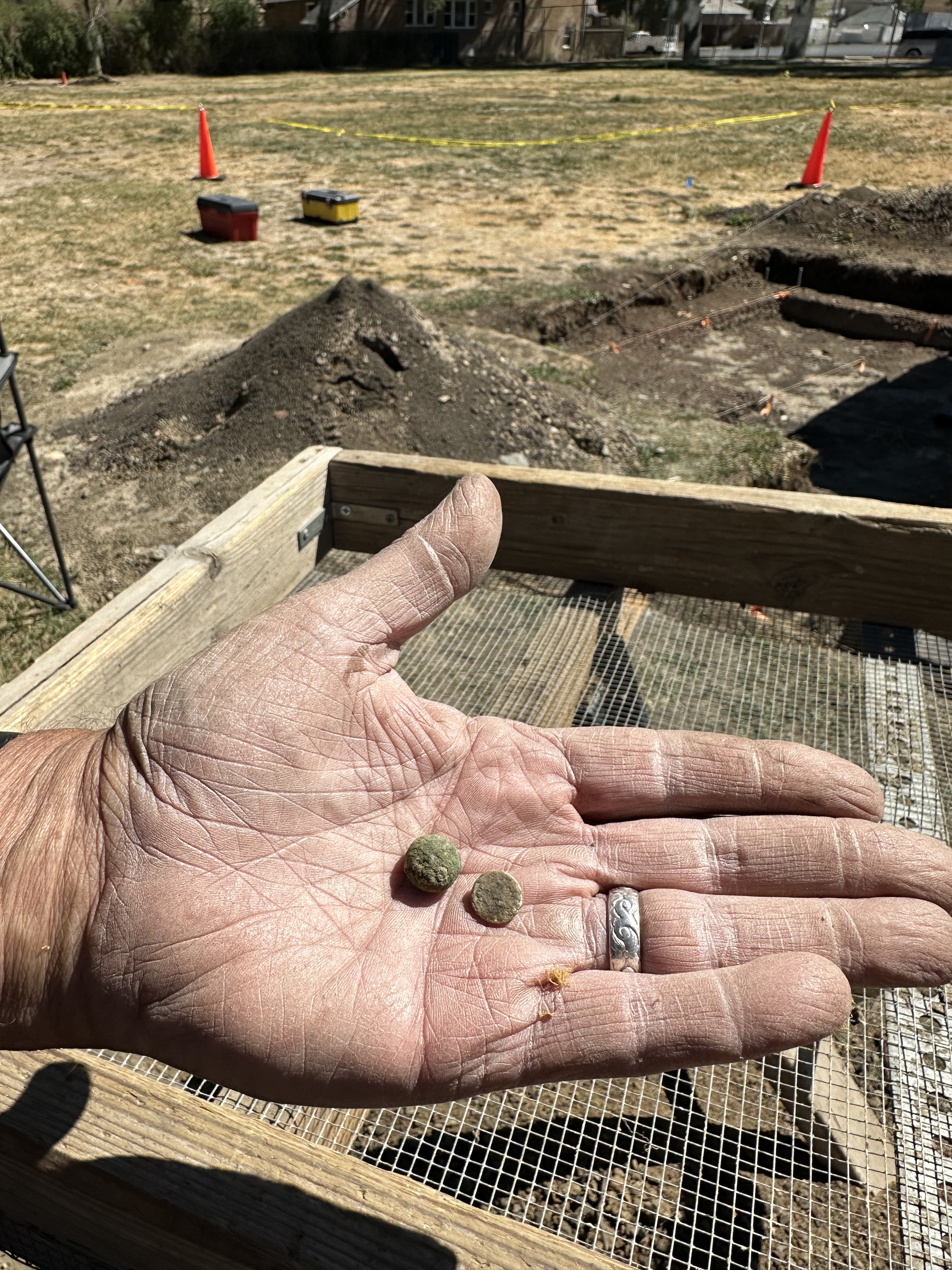 Two game pieces held in a hand