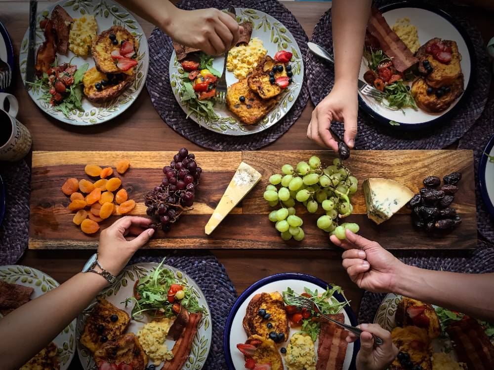 Feast of different foods on a wooden board.