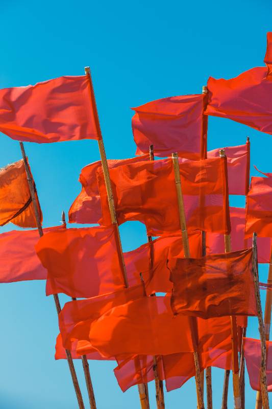 Fishing Boat And Red Flags Flying In Wind