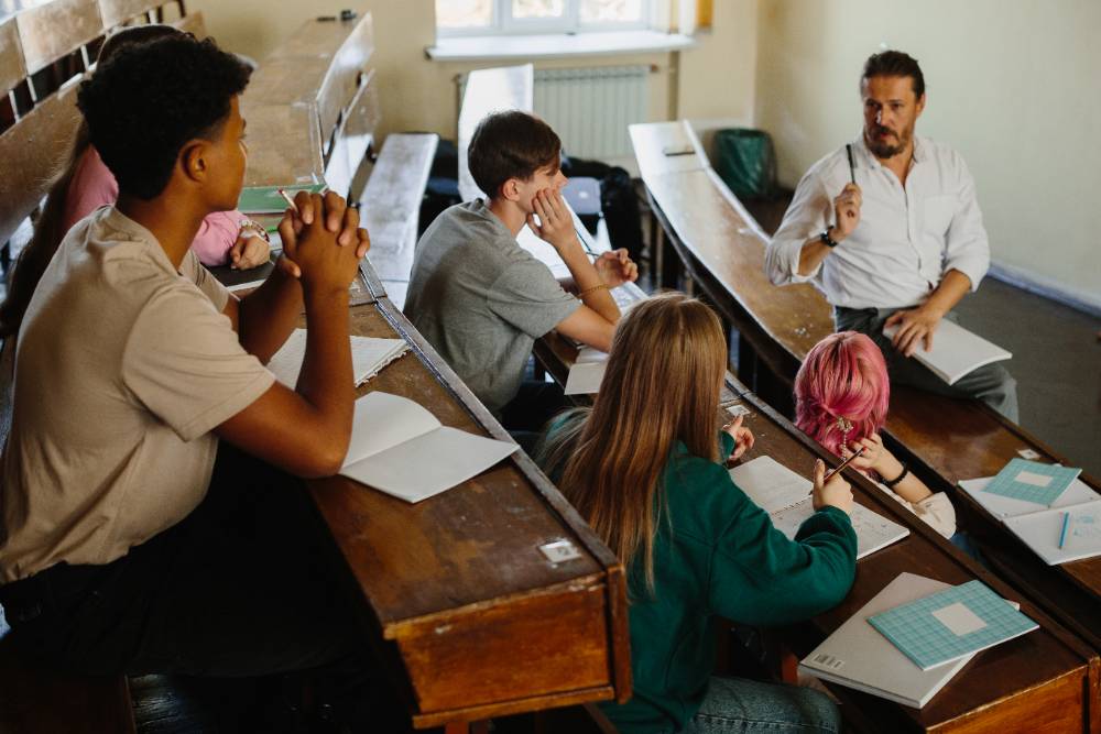 Students and Teacher Engaged in a Classroom Discussion in Lecture Hall